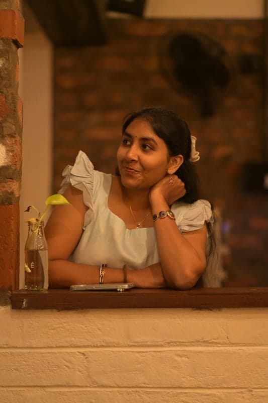 Portrait of Naina Bondada seated at a cafe