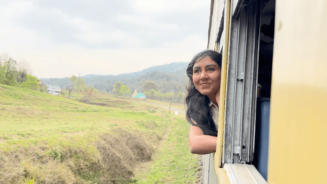 Naina Bondada looking out from a train window during travel