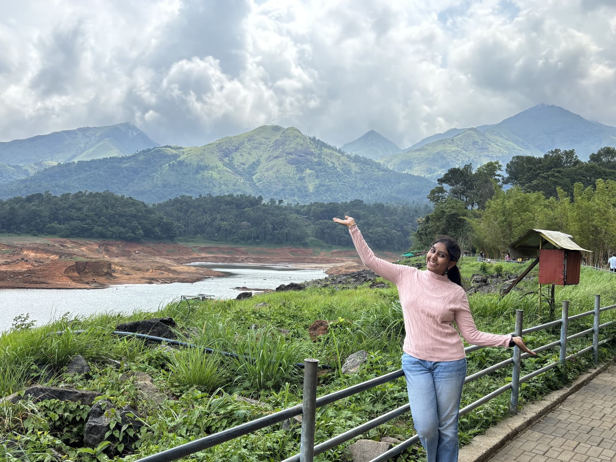 Naina Bondada posing against a scenic mountain and lake backdrop